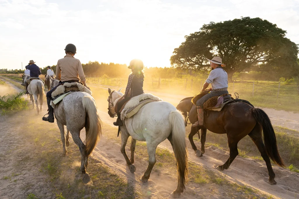 3 riders on horses at golden hour in Corrientes