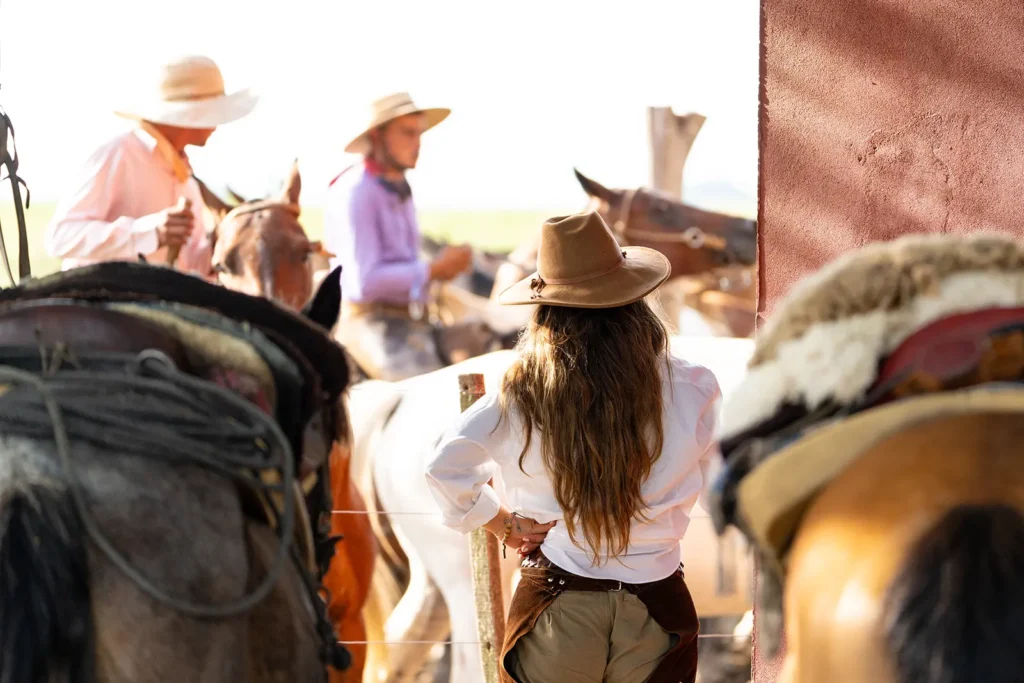 View of gauchos and female rider dressed in the gaucho style